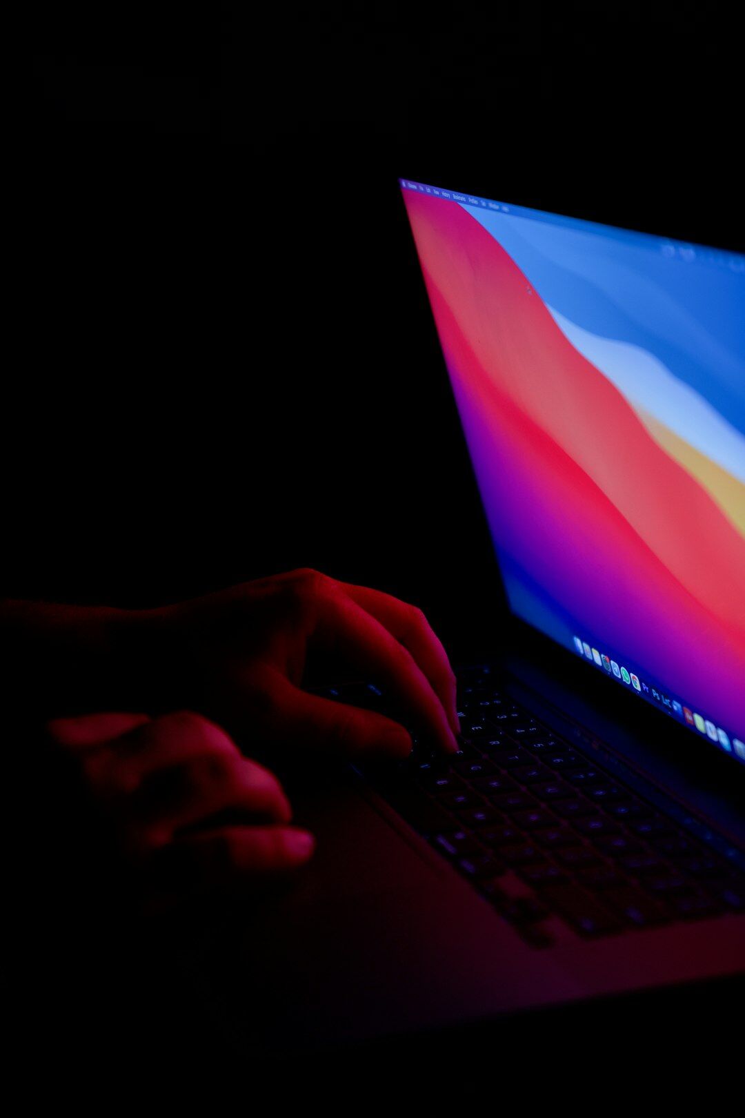 person using laptop at night
